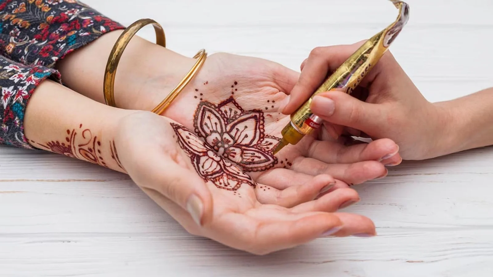 Professional Mehndi Artist applying intricate bridal henna design
